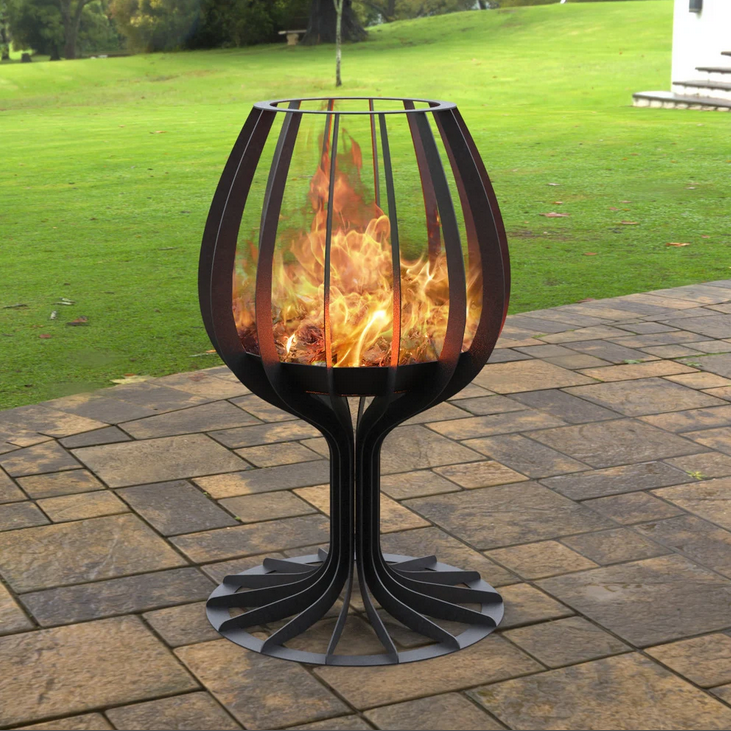 Outdoor fire pit on a patio with grassy area in the background
