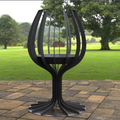 Black metal outdoor table with a garden background