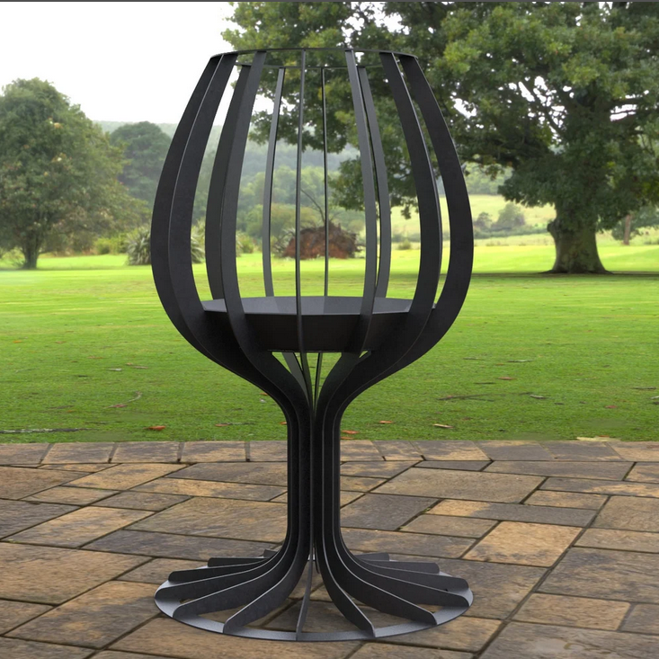 Black metal outdoor table with a garden background