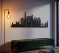 City skyline wall art above a green bench with a floor lamp on a light background